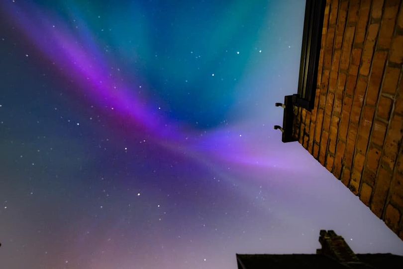aurora in the sky above a building