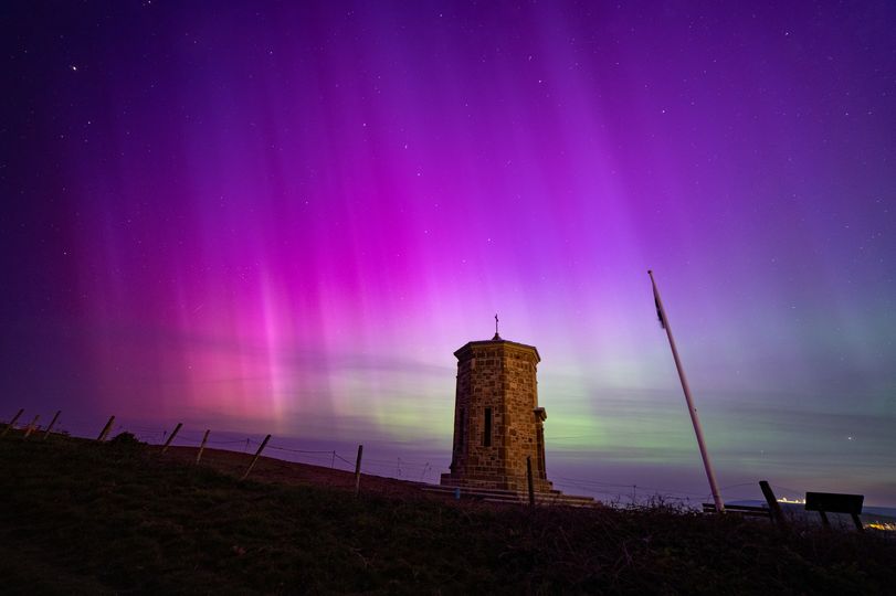 a tower seen against Aurora sky